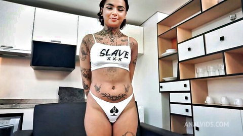 Tattooed Annie Clementine in slave lingerie with queen of spades thong
