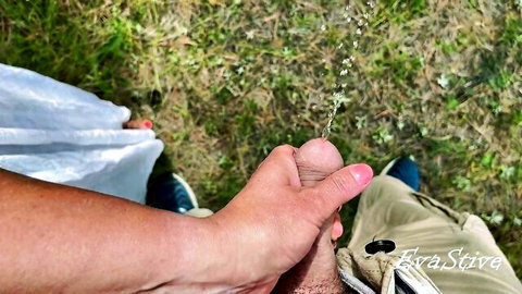 POV hand holding erect penis while peeing outdoors, playing with urine drip