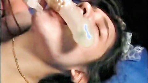 Asian woman with long black hair giving deep oral in uncensored close-up