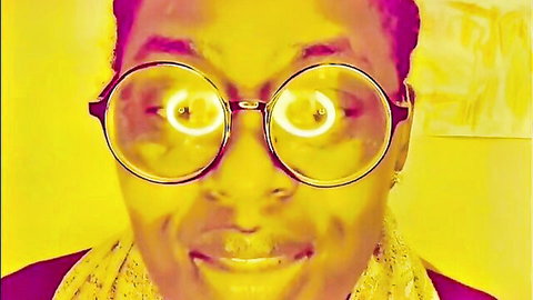 SLUTTYMELANIN close-up in glowing pink glasses for Q&A