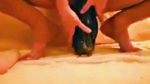 Sexy woman squatting and inserting large black dildo into her pussy