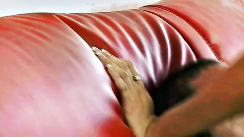 Mommy with wonderful big tits gripping red leather seat seductively