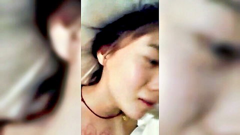 Cute Chinese girl's blurry close-up face and neck with red necklace