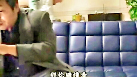 Japanese stepmom in white top with son in suit on blue couch
