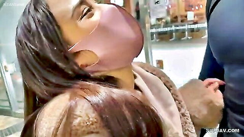 Masked Asian woman gropes man's crotch bulge in public store tease