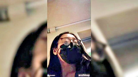 Blurry Filipina Pinay Marsell in glasses and mask looking up teasingly