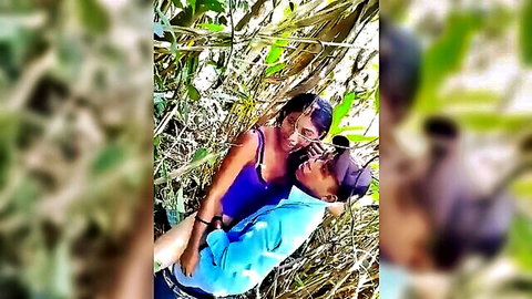Guatemalan Latina couple embracing intimately in lush woods outdoors