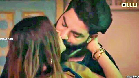 Bearded Indian man passionately kissing saree-clad woman in steamy intimate scene
