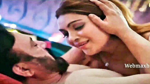 Indian brunette grabs bearded man's face for intense passionate kiss in bed