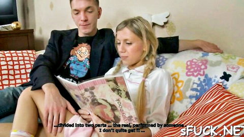 Blonde Kelsie in pigtails and white shirt cozy with man on couch