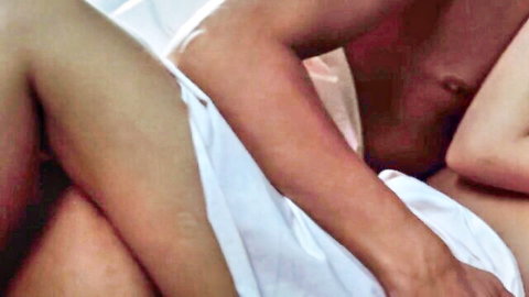 Topless woman with medium tits fucked from behind by muscular man on bed