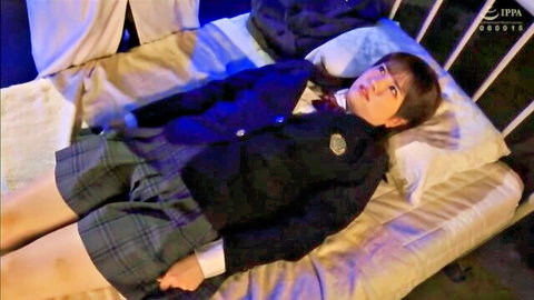 Asian schoolgirl in navy uniform lying seductively on bed