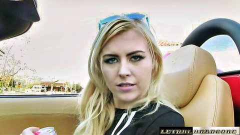Blonde babe with long hair and sunglasses on head sitting in red convertible car with open mouth