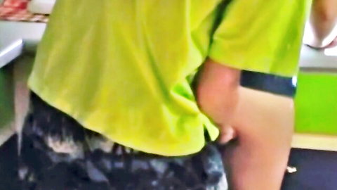 Alluring blonde teen bent over, exposing firm ass in green top and shorts