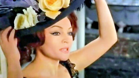 Sara Montiel in glamorous red hair and floral hat, seductive pose from 1966 film