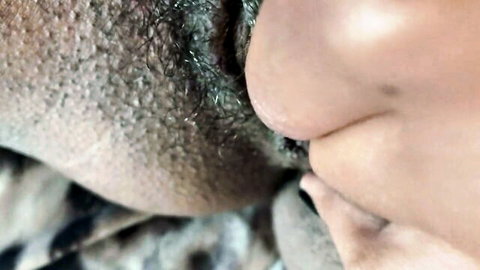 Close-up of hairy ebony pussy with thick dark bush and swollen labia