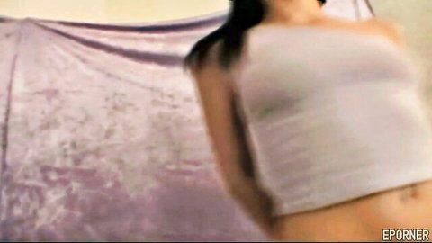 Skinny brunette teen teasing in tight white tank top exposing flat midriff