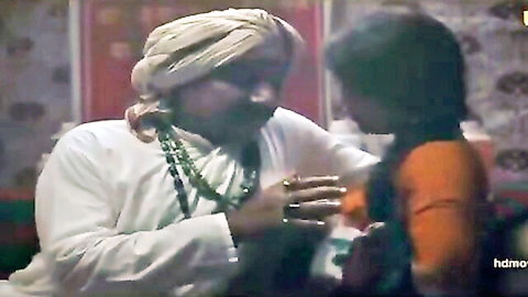 Indian mature man in turban seducing young woman in orange dress, Ullu series