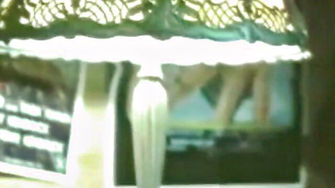 Blurry thumbnail of old school porn stars interview setup with lamp and screen display