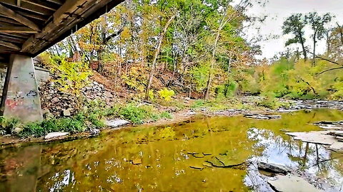 Scenic autumn woods under rustic covered bridge, outdoor fetish spot for piss and cum play