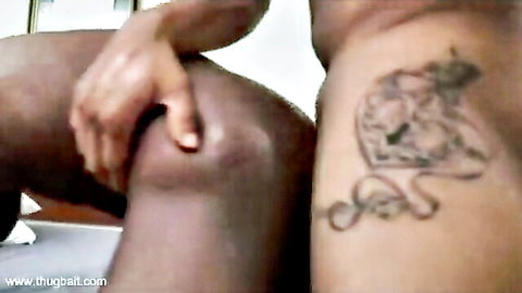 Ebony man's thick black cock and tattooed muscular thigh gripped by a woman's hand