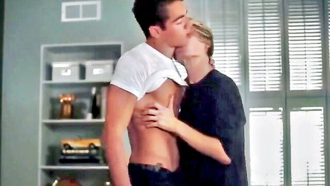 Muscular hunk lifts white shirt exposing ripped abs as lover kisses and caresses his toned stomach passionately