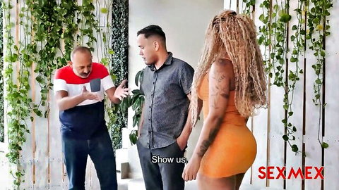 Sexy ebony cougar in tight orange dress teases with two men