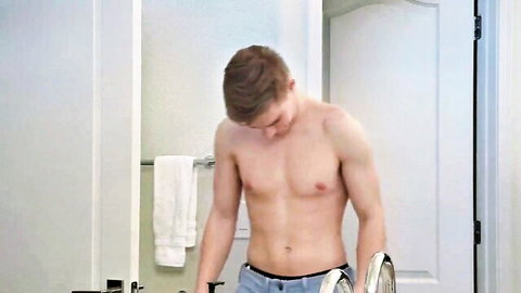 Shirtless athletic young man in blue underwear in steamy scene