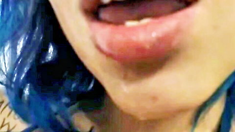 Blue-haired Asian model Misskiss4you teases with wet lip licking close-up
