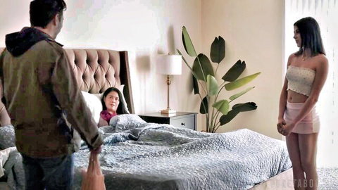 Older man enters bedroom holding bag eyeing young brunette in pink tube top and shorts while another brunette lies in bed