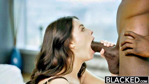 Cute brunette in stockings gives blowjob to huge black cock