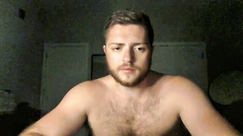 Muscular hairy bearded man shirtless in dim bedroom adult video thumbnail