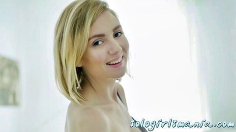 Smiling blonde solo teen posing topless showing small perky tits