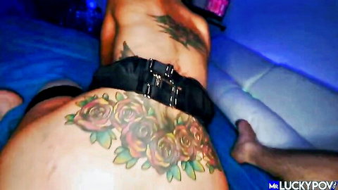 Tattooed bubble butt babe in black harness spreads ass on couch for POV