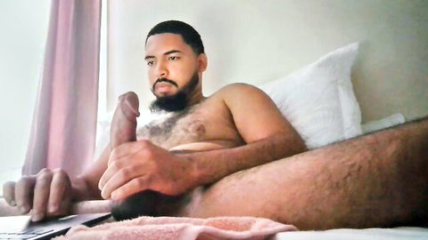 Muscular bearded ebony man stroking his thick cock solo