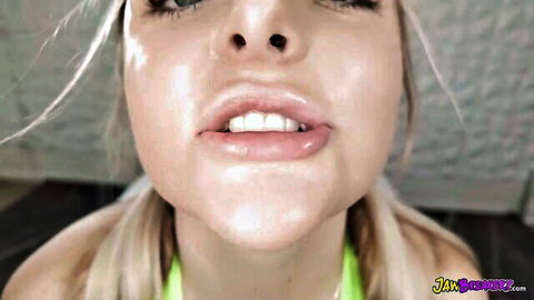 Close-up of blonde teen's glossy lips and tongue, teasing blowjob pose