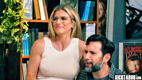 Blonde woman in tank top gazes at bearded man in plaid shirt