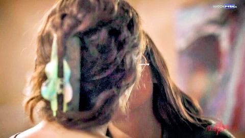 Brunette with long wavy hair and green clip viewed from behind in steamy porn scene