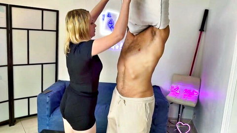Blonde Lola in black outfit lifts shirt off muscular man's abs in naughty tease