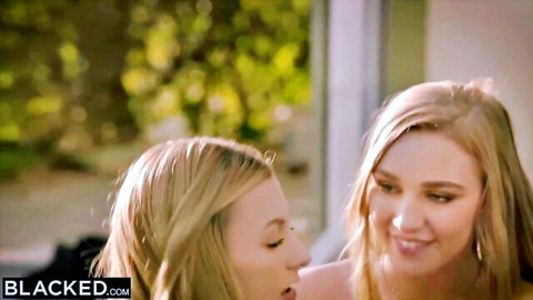 Kendra Sunderland and blonde friend smiling intimately outdoors