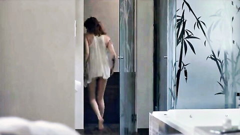 Redhead in sheer white mini dress walks barefoot into bathroom teasing her thighs and ass