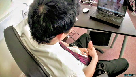 Asian man in shirt and tie masturbates at desk to trans sex video
