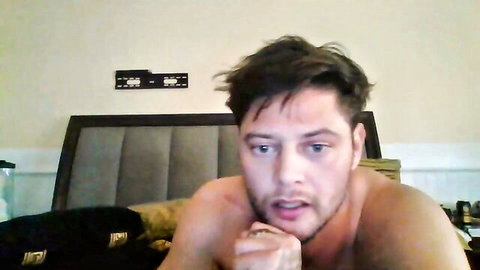 yourpuppets Aussie model shirtless on bed, seductive gaze in Chaturbate video
