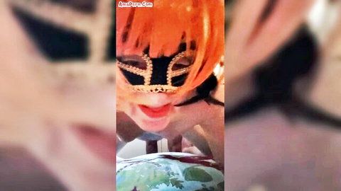 Masked orange-haired trans woman smiling during intense fuck scene