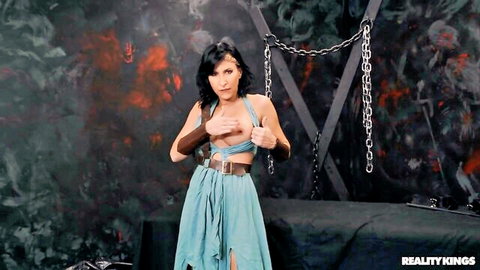 Sexy brunette MILF in revealing fantasy dungeon outfit with chains