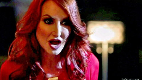 Shocked redhead MILF with mouth wide open screaming in sexy red dress