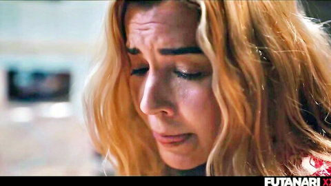 Close-up of teary-eyed blonde woman with intense emotional expression in futanari scene
