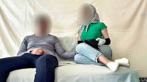 Khalesexii and partner seated intimately in casual attire, Persian amateur tease scene