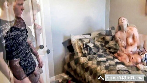 Blonde tattooed woman nude on bed in sister-in-law threesome scene