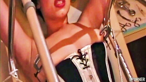 Bound woman in black corset for BDSM mistress training session